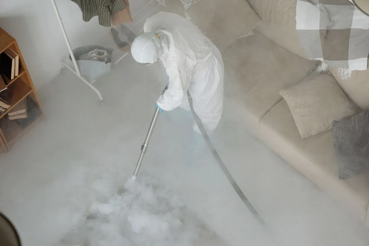 Biohazard cleanup technician in protective equipment, South Side Flats, Pittsburgh, PA